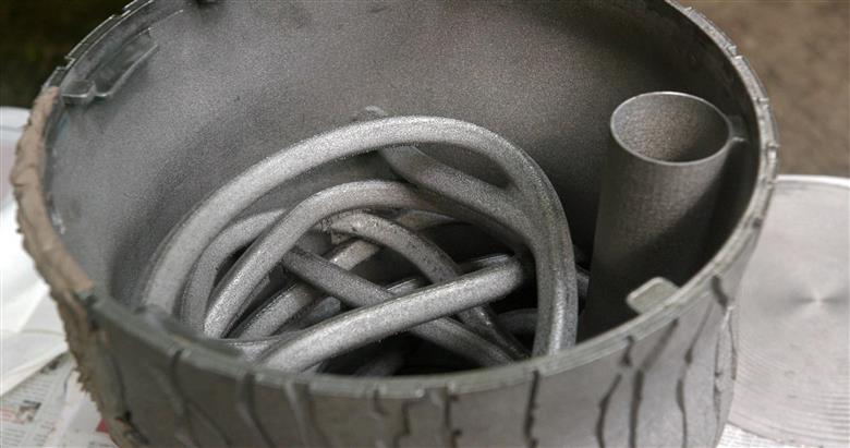 Inside the metal 3D printed cricket feeder. Device installed at the Discovery Rainforest at Cincinnati Zoo.
(Photo: GE Additive, GEADPR037)
