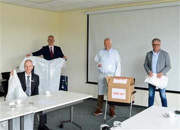 Alfons Kruse (second from right), plant manager Mondi Steinfeld, and Detlef Stöppelmann (right), production leader Mondi Steinfeld, hand over the first 100 garments to Wolfram Van Lessen (left) and Cord Bockhop (second from left) representing the regional district’s Civil Protection Authority in Diepholz, Germany. (Photo: Mondi, PR149)