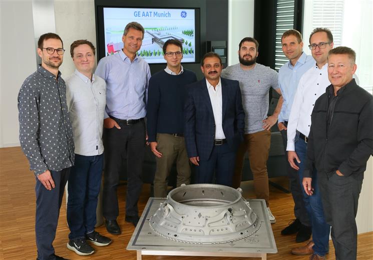 From right to left: Dr. Hermann Scheugenflug (GE Aerospace), Dr. Dirk Herzog (TUHH), Dr. Andreas Peters (GE Aerospace), Nick Markovic (Autodesk), Ashish Sharma (GE Aerospace, Project Leader), Dr. Andrea Milli (GE Aerospace), Dr. Guenter Wilfert (GE Aerospace), Andy Harris (Autodesk), Philipp Manger (Autodesk). Image credit: GE Aerospace. 
(Photo: GE Additive, GEADPR067)
